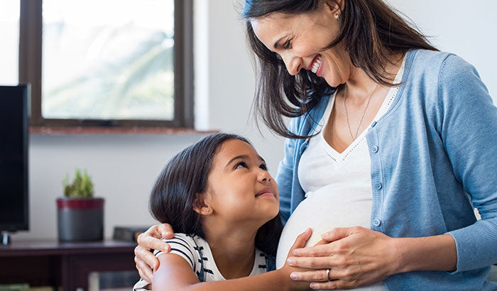 mom and daughter smiling at each other