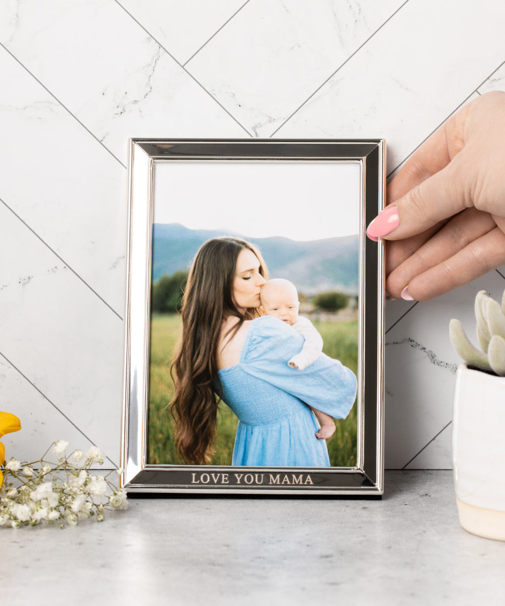 A custom silver photo frame with intricate designs, perfect for displaying cherished memories.