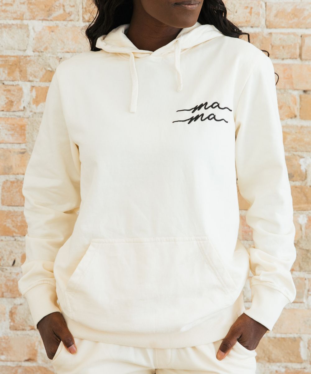 White hoodie with the word "mama" written on it.
