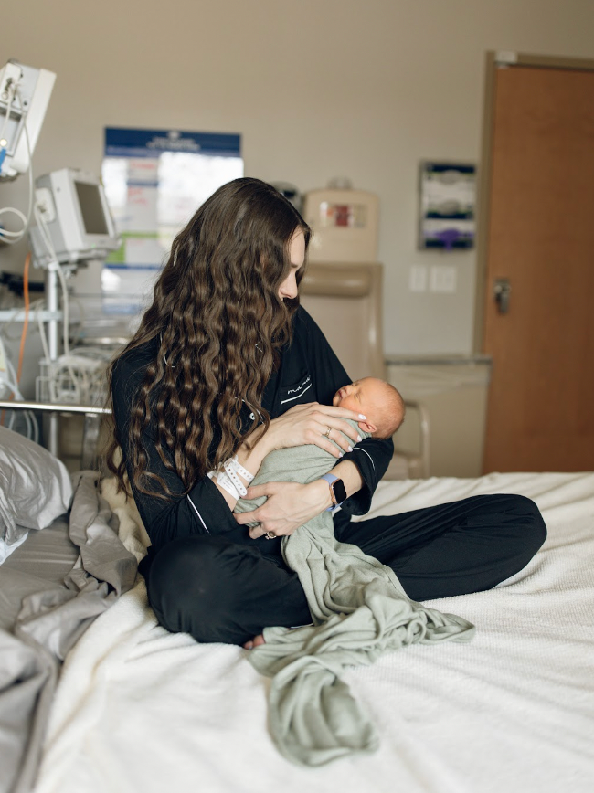 A mother cradling her newborn baby in a hospital bed, filled with love and joy.