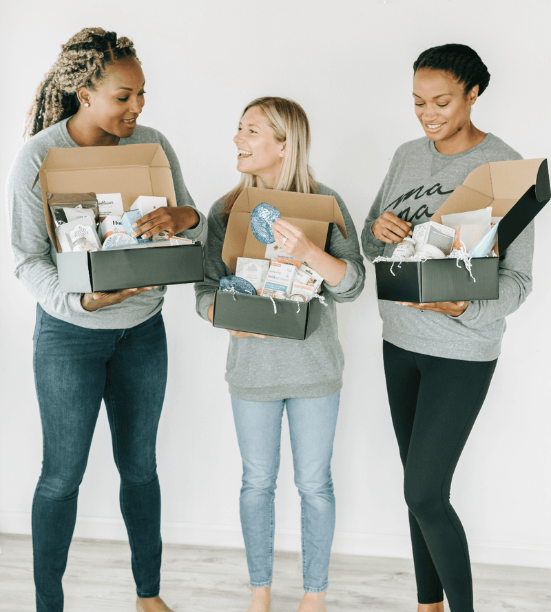 pregnant mom holding their gift box set