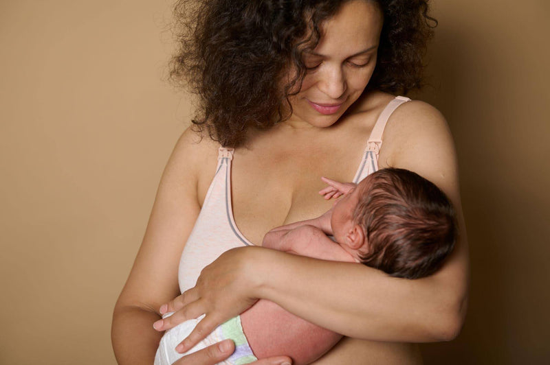 A woman holds a baby close to her chest embodying warmth and nurturing in a loving embrace