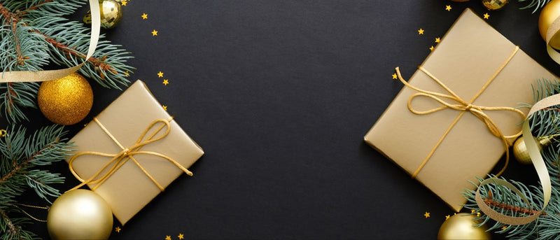 Golden Christmas gifts arranged elegantly on a black background, perfect for postpartum care and motherhood celebrations.