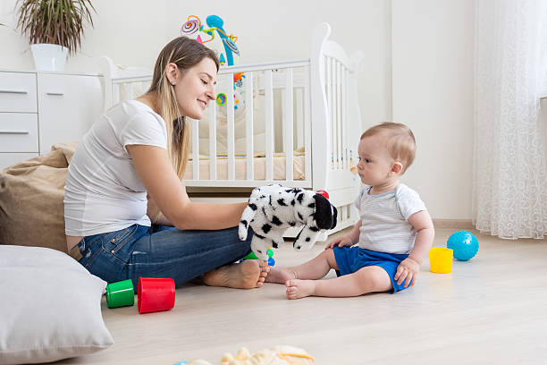 mom playing with her child with puppet