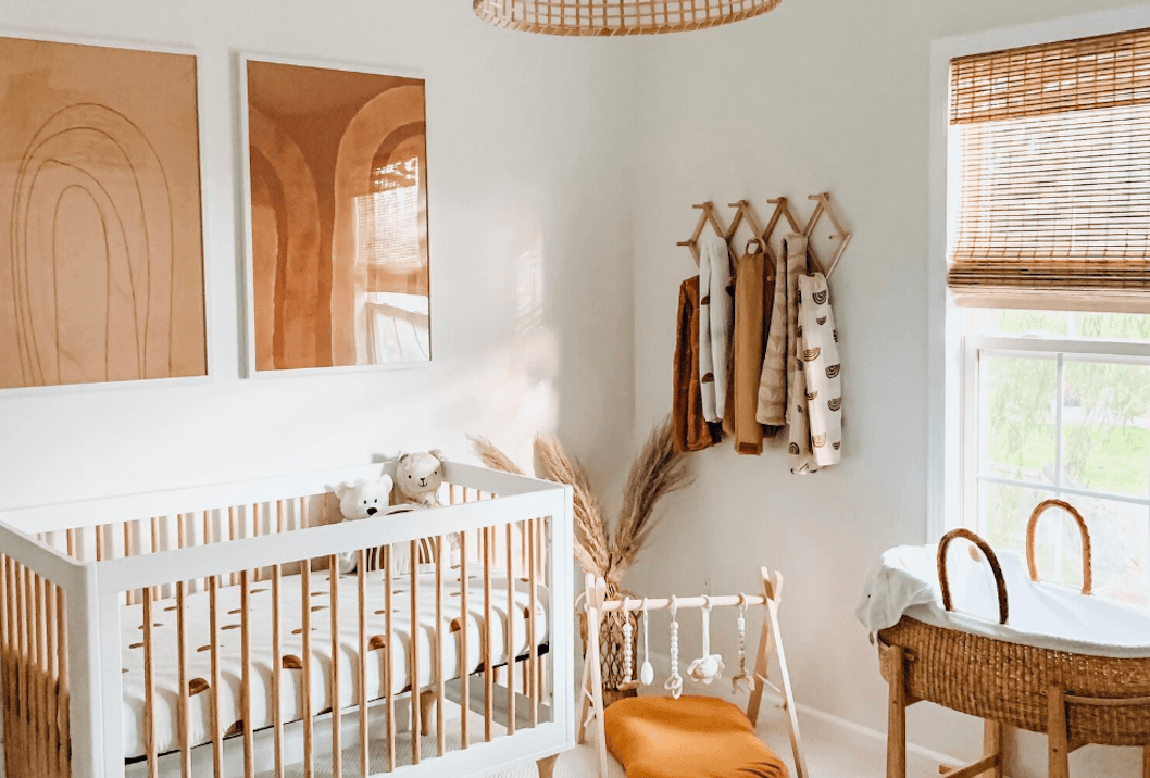 minimalist room with white and brown wooden crib and table