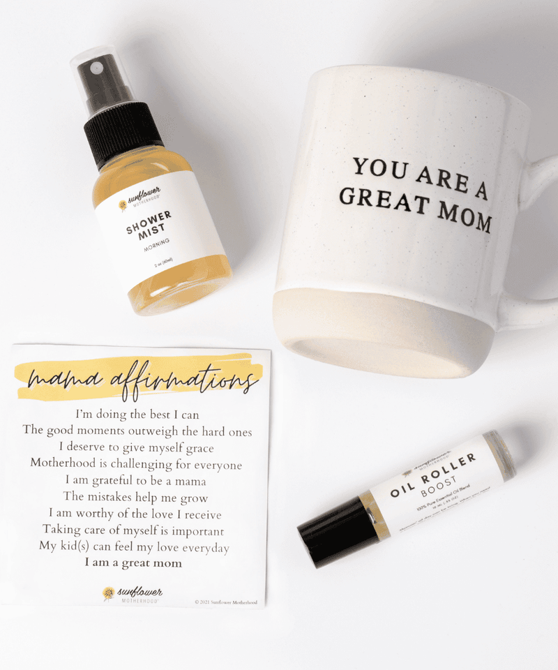 a shower mist in a spray and a oil roller and a mug of you are a great mom