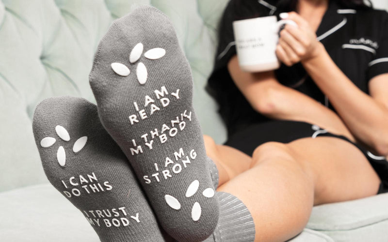 a gray socks waring by a woman with a black lingerie