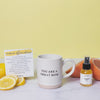 A mug and a kettle lemon and orange